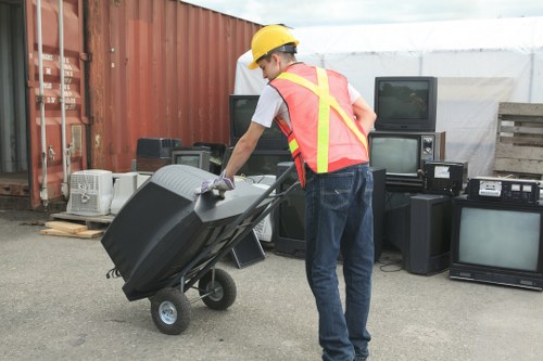 Modern office furniture being removed during clearance